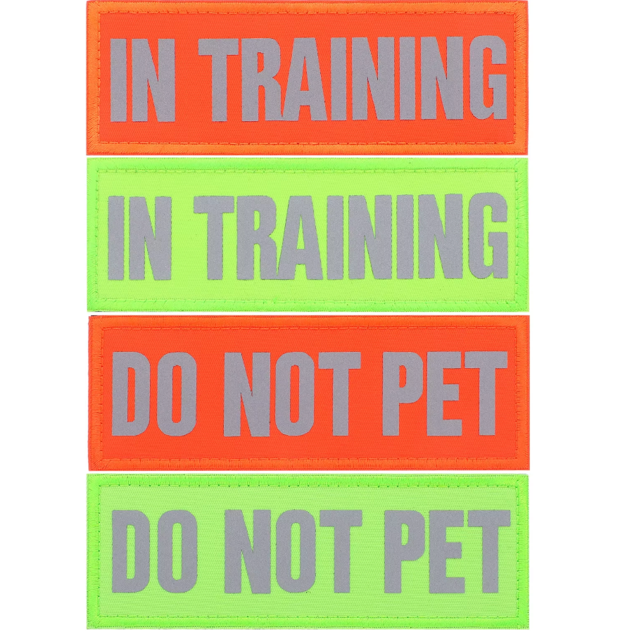 Two rectangular signs with 'IN TRAINING' and 'DO NOT PET' text on a white background.